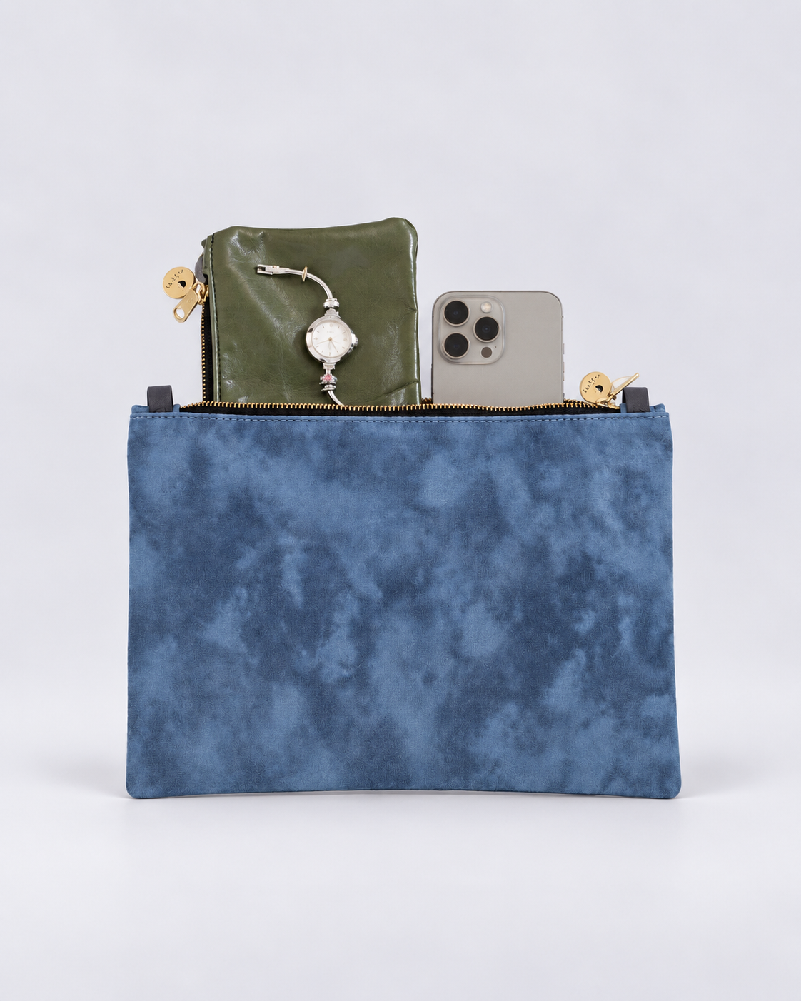 A blue textured zippered clutch pouch shown open, containing an olive green wallet, a silver pendant, and a gray smartphone, on a light gray background.